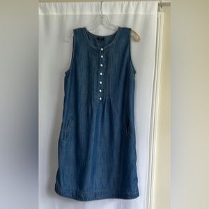 Sleeveless denim dress. Pin tuck detail on bodice. Side pockets. Gently worn.